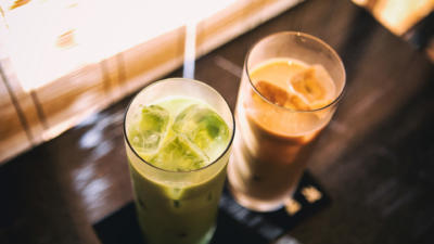 close up shot of two iced drinks - one green, one brown